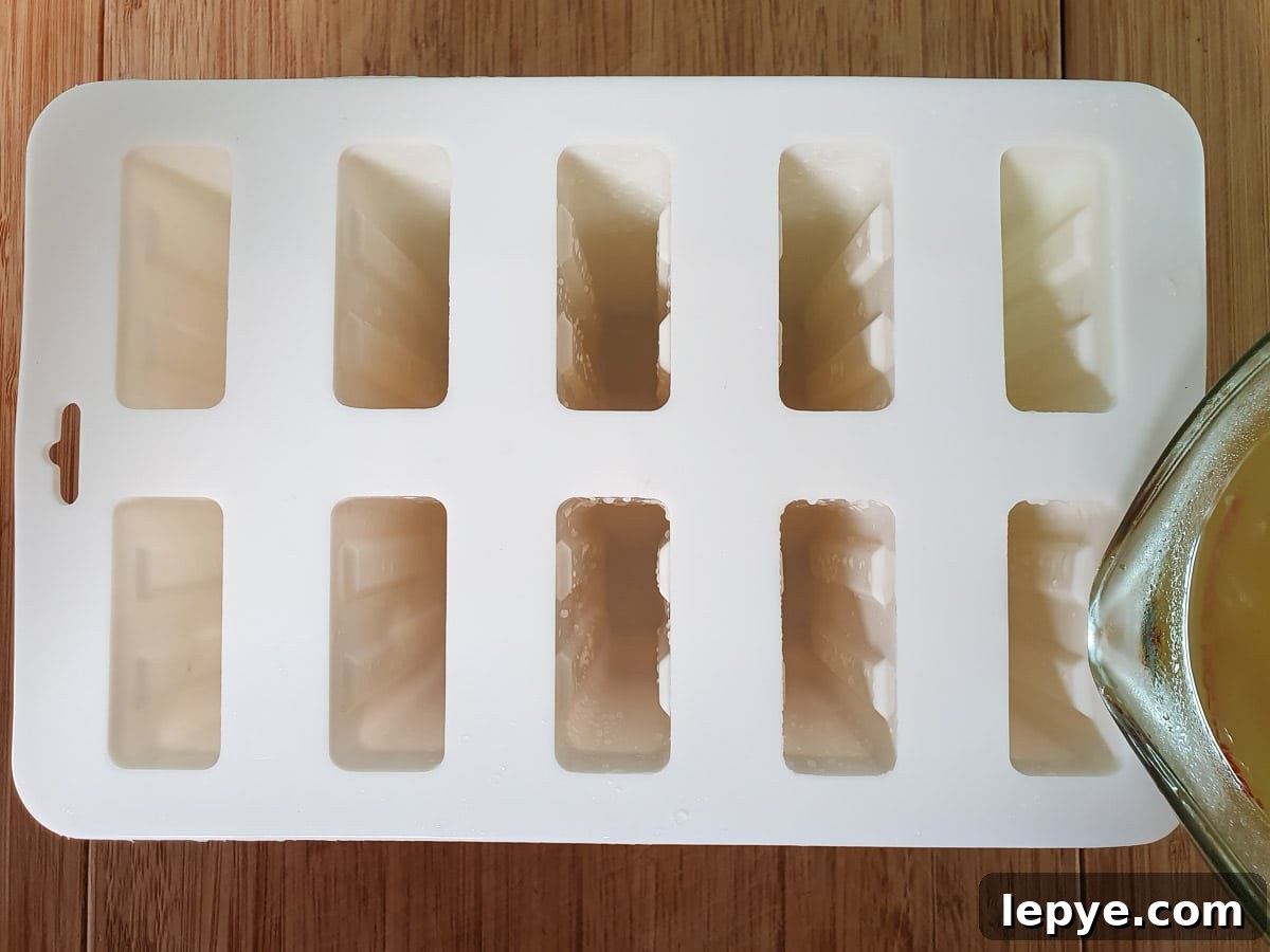 Refreshing Lime Popsicle Recipe: Homemade Citrus Ice Pops 9 Pouring mix into popsicle molds.