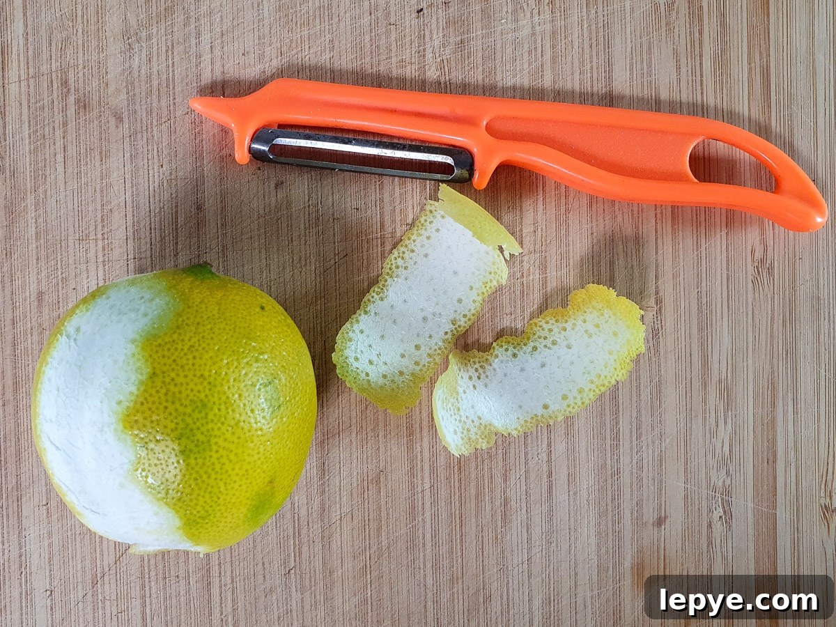 Refreshing Lime Popsicle Recipe: Homemade Citrus Ice Pops 4 Using a peeler to peel zest strips off two limes.