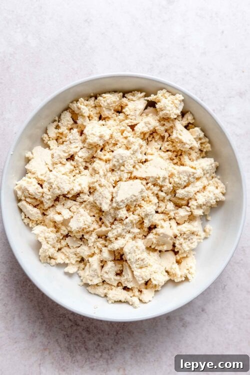 Crumbled firm tofu in a bowl.