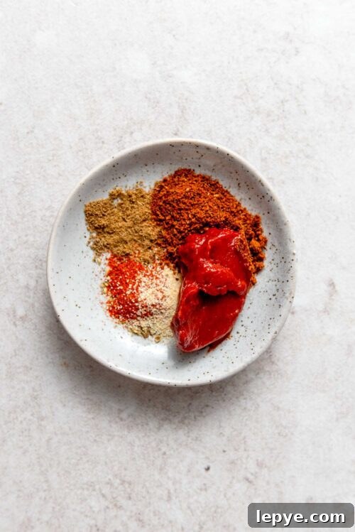 Taco spices and tomato paste in a small dish.