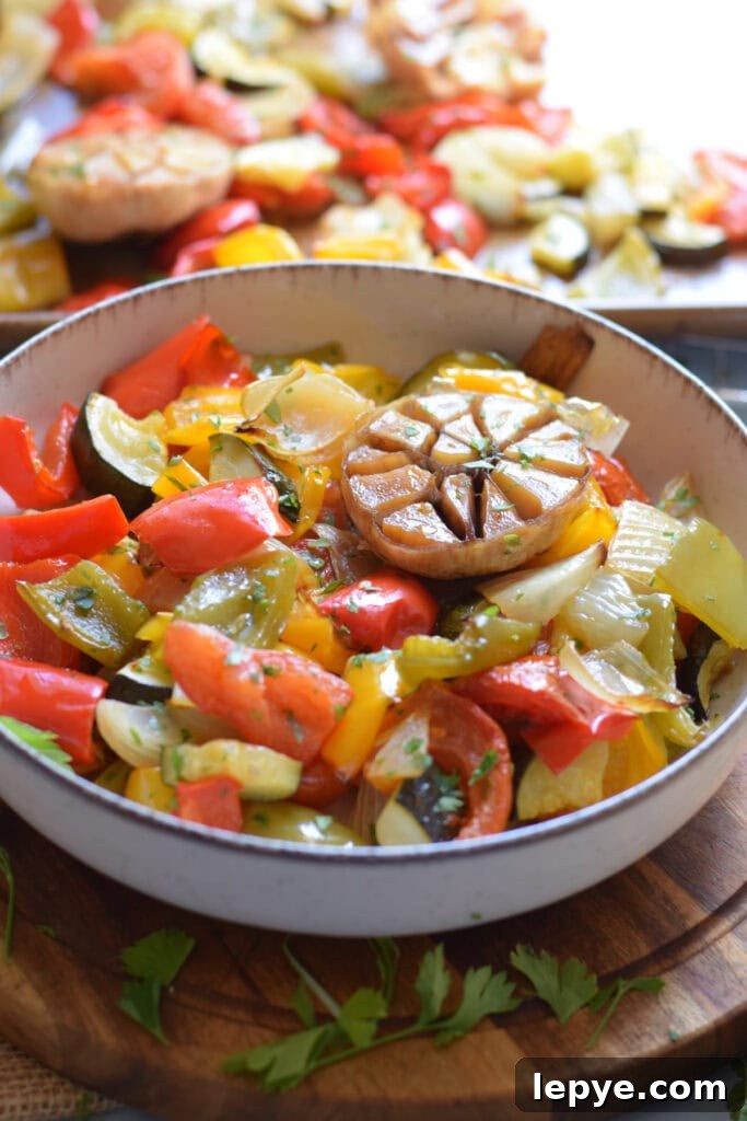 Mediterranean Sheet Pan Roasted Vegetables for Weeknight Meals 14 Roasted peppers and tomatoes in a bowl.
