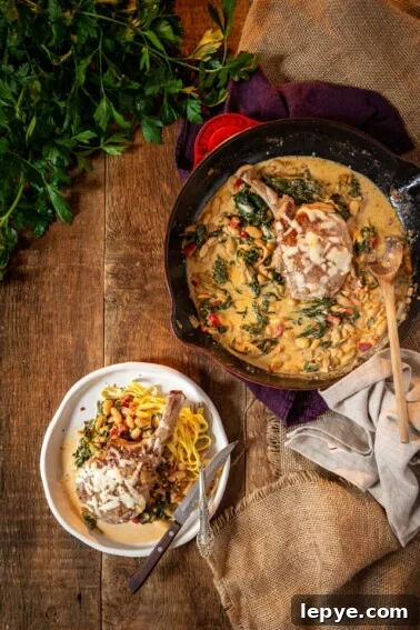 Garlic Herb Pork Chop Marinade for Juicy, Flavorful Chops 10 bone n pork chops on a plate with creamy sauce loaded with spinach, beans and roasted red peppers