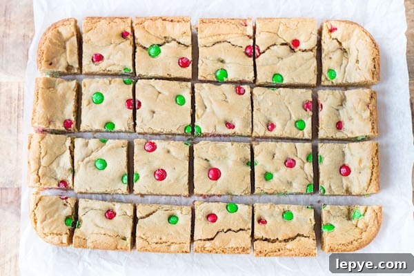 Peanut Butter M&M Blondies straight out of the oven cut into squares and ready to be served