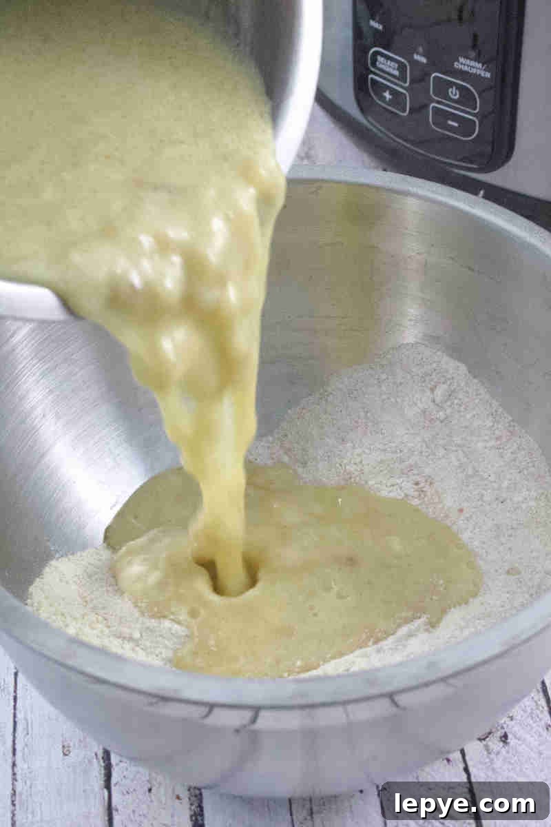 High-Protein Slow Cooker Banana Bread Recipe 6 Gluten-free banana bread mixture being poured into a slow cooker lined with parchment paper.