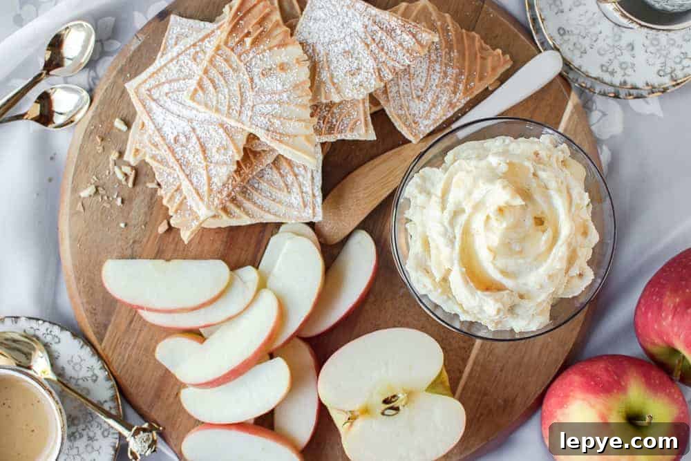 sweet ricotta on a board with apple slices and pizzelle.