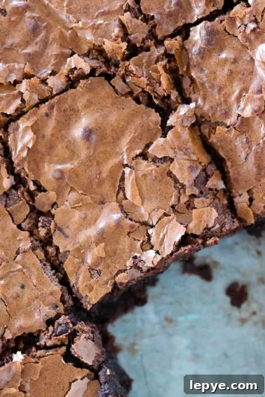 Fudgy Banana Brownies Made with Ripe Bananas 16 brownies flaky top sliced in pan.