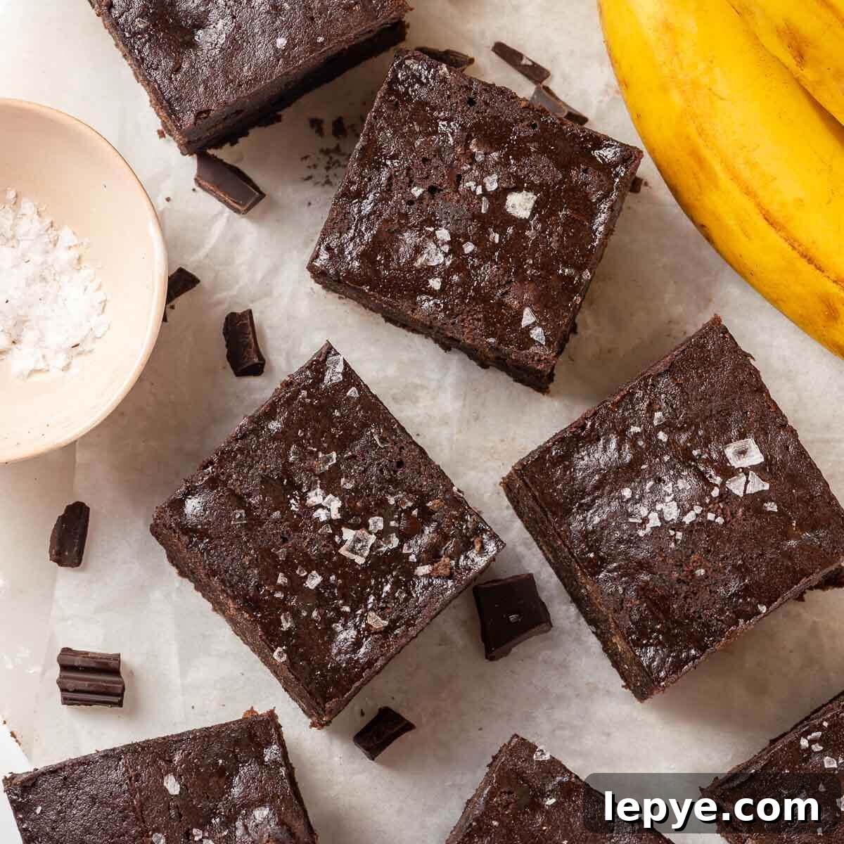 Fudgy Banana Brownies Made with Ripe Bananas 5 Ripe bananas used for banana brownies next to brownie squares.
