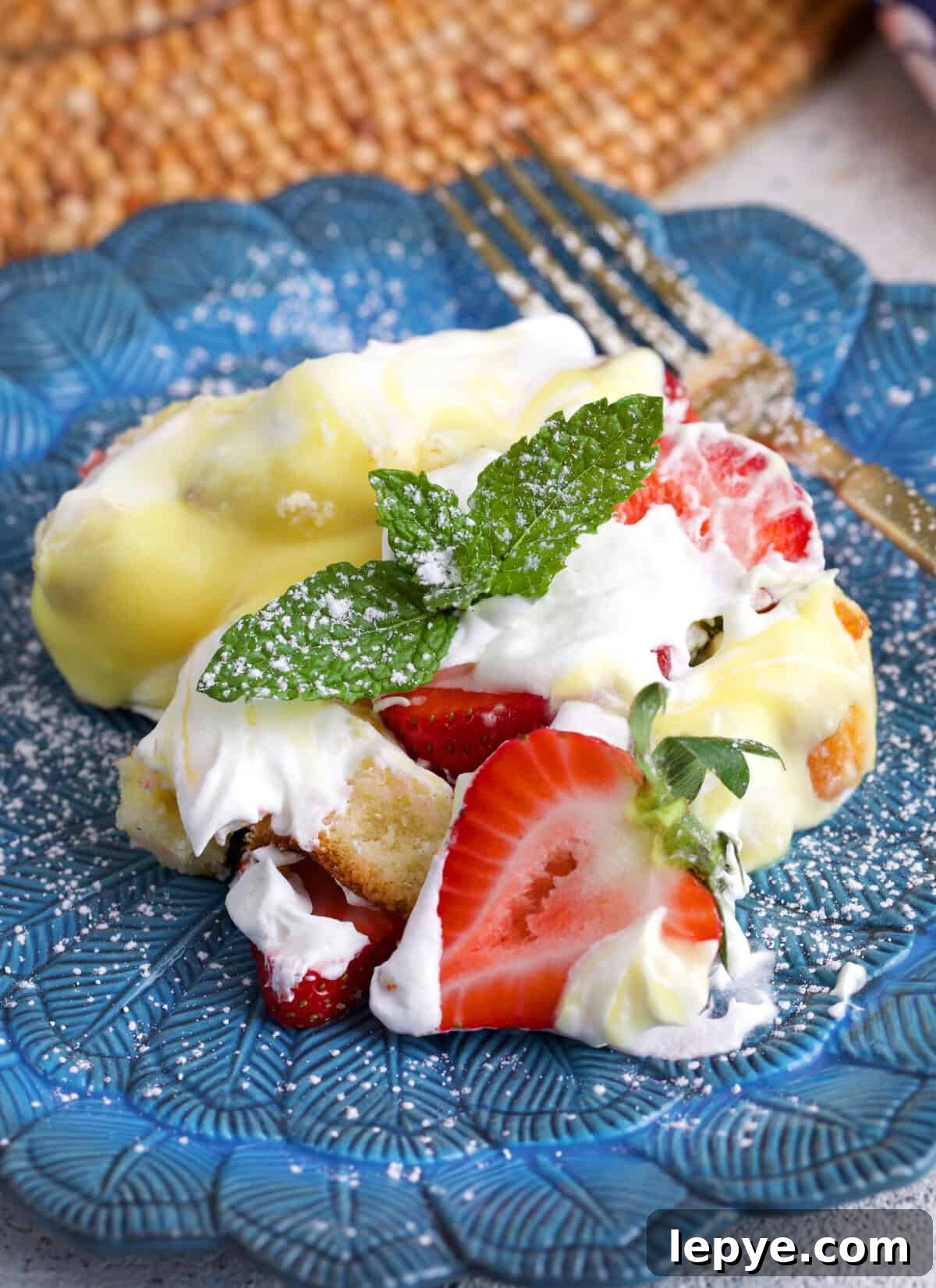 Strawberry Trifle Recipe with Layered Cream and Fresh Berries 6 Serving of strawberry trifle on a blue plate