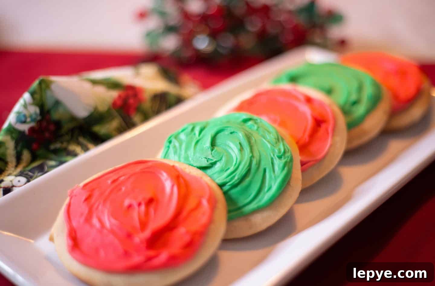 Southern Soul Tea Cake with Sweet Icing - Classic Recipe 5 How to make traditional tea cakes with icing - A row of iced tea cakes in alternating red and green frosting, styled on a holiday platter. These Christmas cookies reflect soulful Southern tradition and visual appeal. Recipe and tips by Shaunda Necole & The Soul Food Pot®.