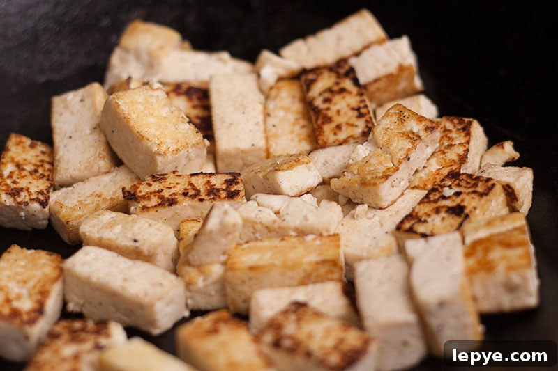 Ironic Thai Fried Rice with Tofu or Prawns 2 Stir fried tofu in a wok