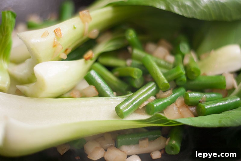 Ironic Thai Fried Rice with Tofu or Prawns 3 Stir fried pak choi and beans in a wok