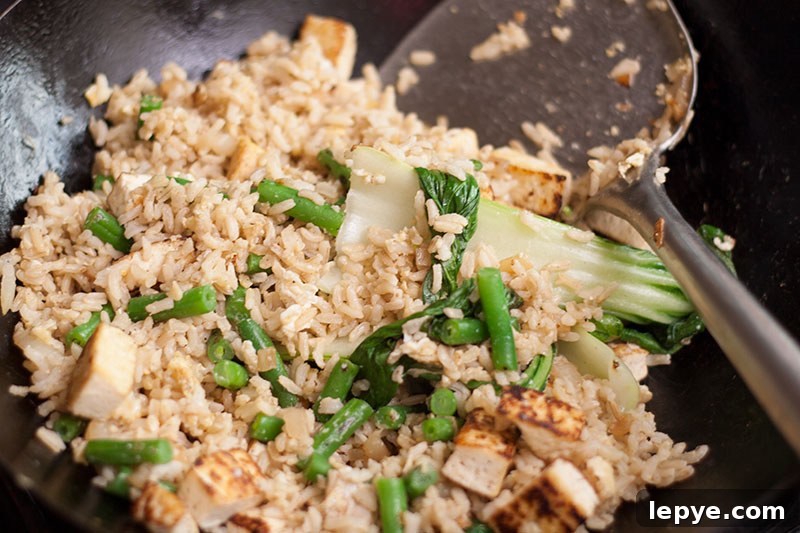 Ironic Thai Fried Rice with Tofu or Prawns 4 Thai fried rice with tofu beans and pak choi in a wok