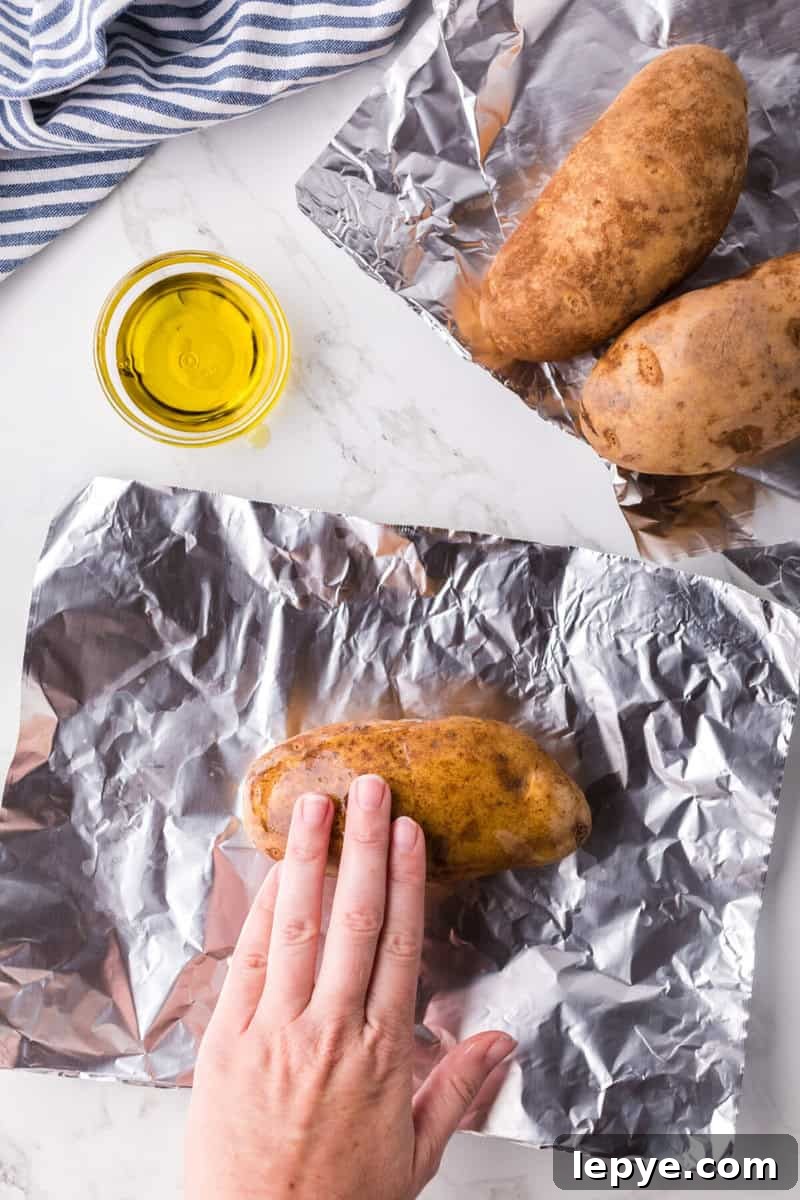 Perfect Slow Cooker Baked Potatoes: Creamy, Hands-Off Recipe 5 rubbing the olive oil on top of the potatoes.