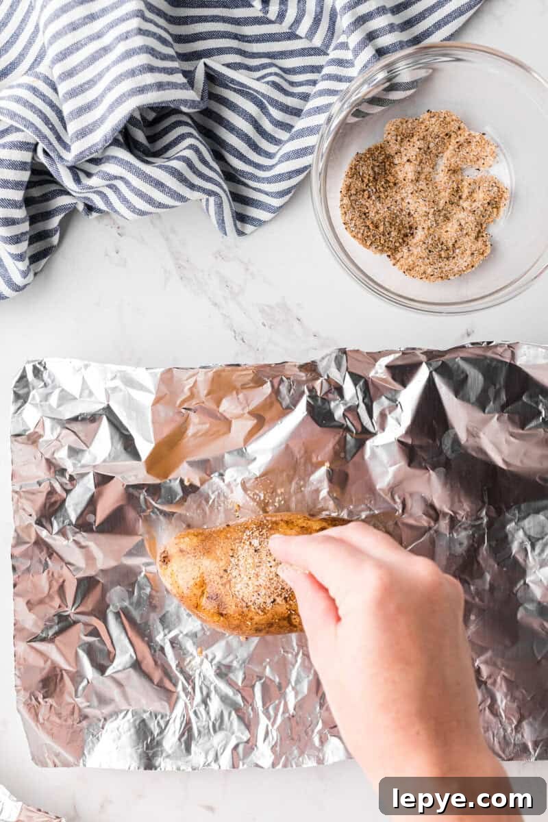 Perfect Slow Cooker Baked Potatoes: Creamy, Hands-Off Recipe 6 seasoning the potatoes before baking.