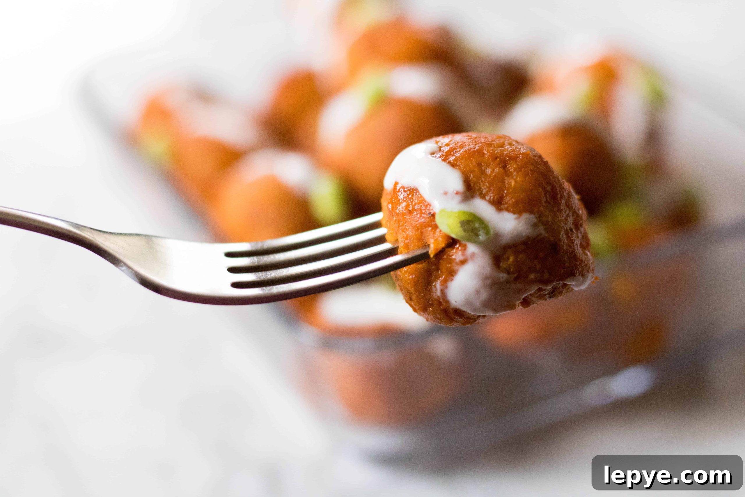 Fork holding a buffalo chicken meatball