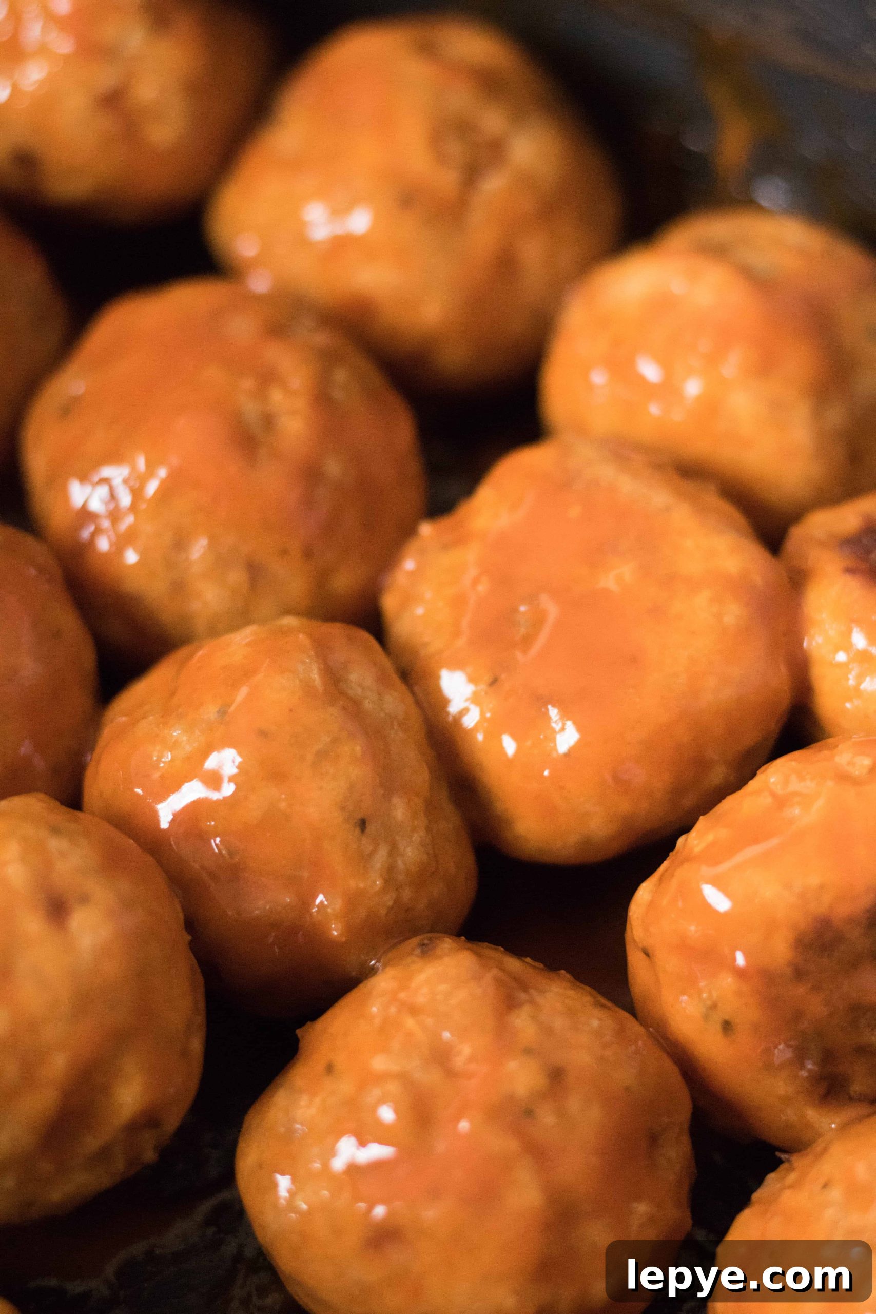 baked chicken meatballs coated in buffalo sauce