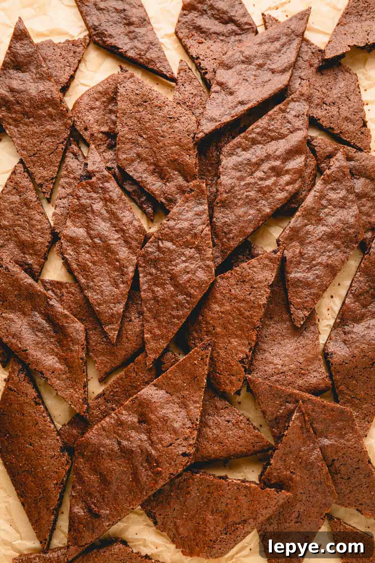 Crunchy Brownie Crisps: Chocolate Bites Recipe 9 Brownie crisp pieces on a parchment paper-lined baking sheet.