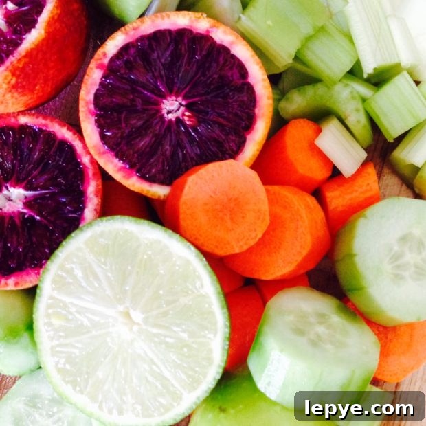 Refreshing Green Smoothie Recipe for Energy and Immunity 3 Close up view of cut up blood orange, carrots, celery, cucumbers and green apple.