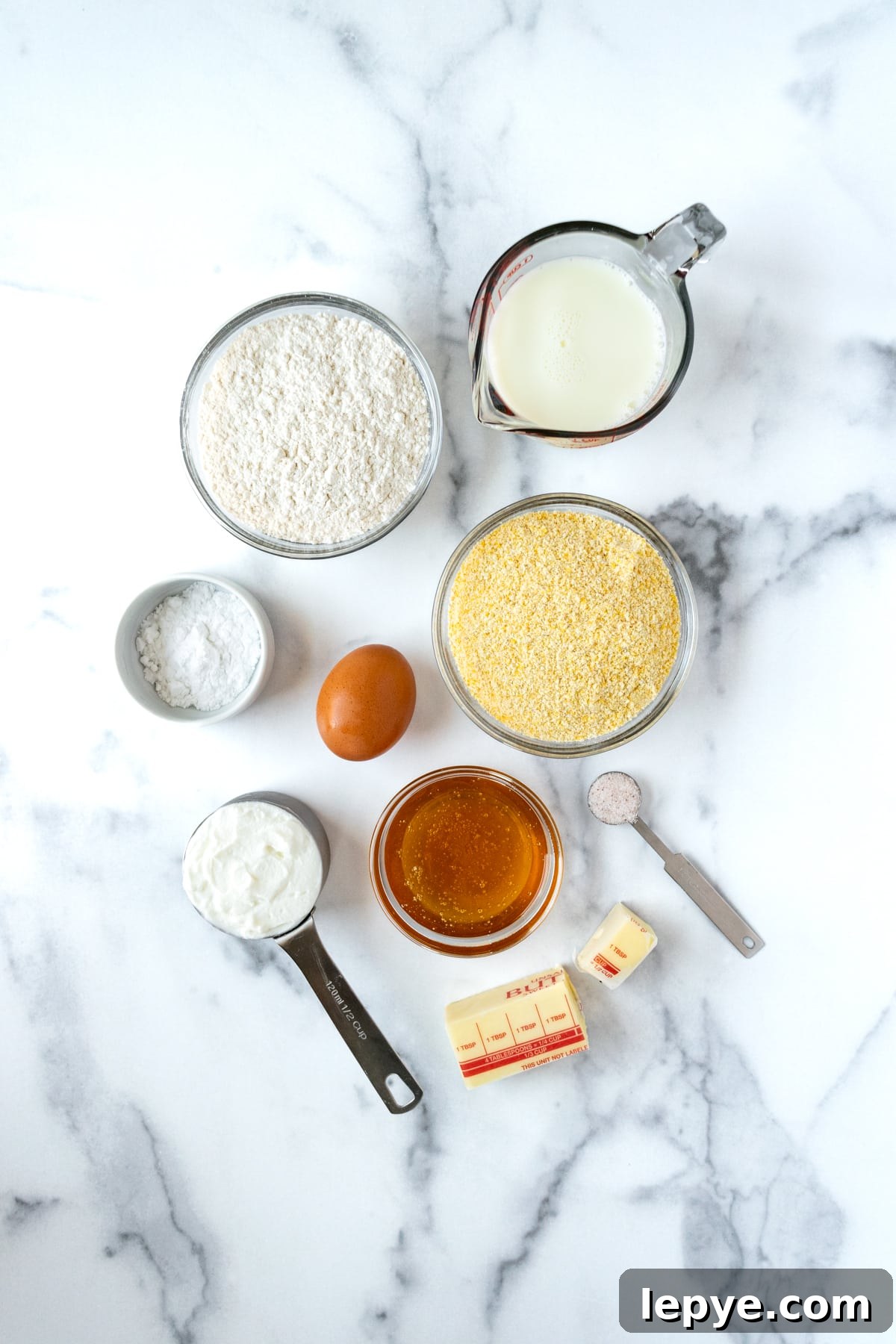Honey-Glazed Cornbread Recipe with Golden Crust and Sweet Drizzle 3 Honey Glazed Cornbread Ingredients on a marble countertop.
