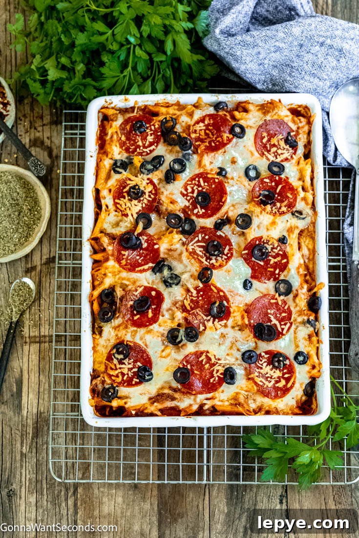 Our deliciously hearty pizza casserole will be kids of all ages will race to the dinner table when this is on the menu! Ooey-gooey, cheese YUM! pepperoni pizza casserole top shot