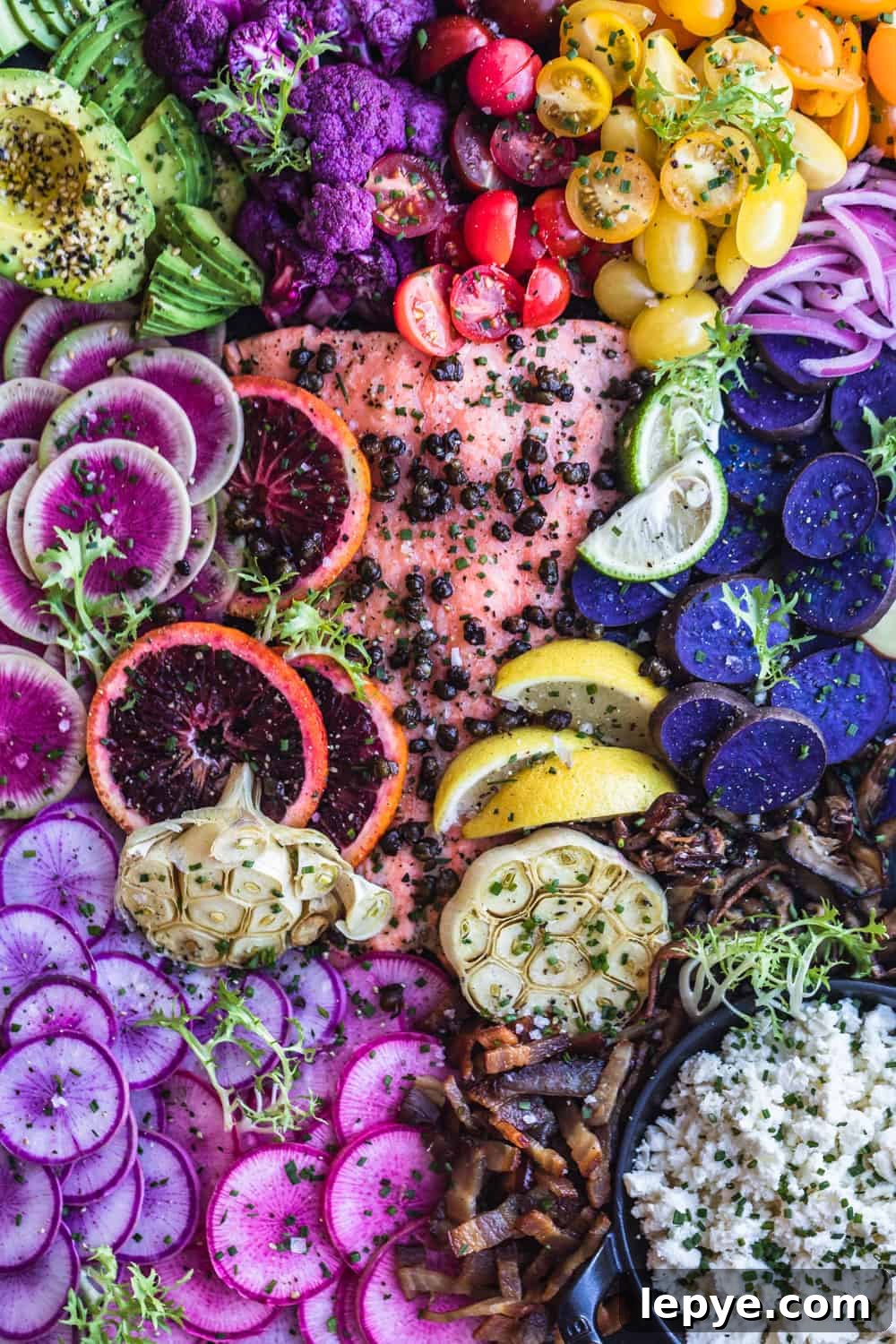 Vibrant Salmon Rainbow Salad Board for Entertaining 2 Salmon Rainbow Party Salad Board with avocado, purple cauliflower, tomatoes, red onions, purple patties, pink and purple radishes, bacon, cheese, garlic, blood orange and watermelon radishes. Up close.