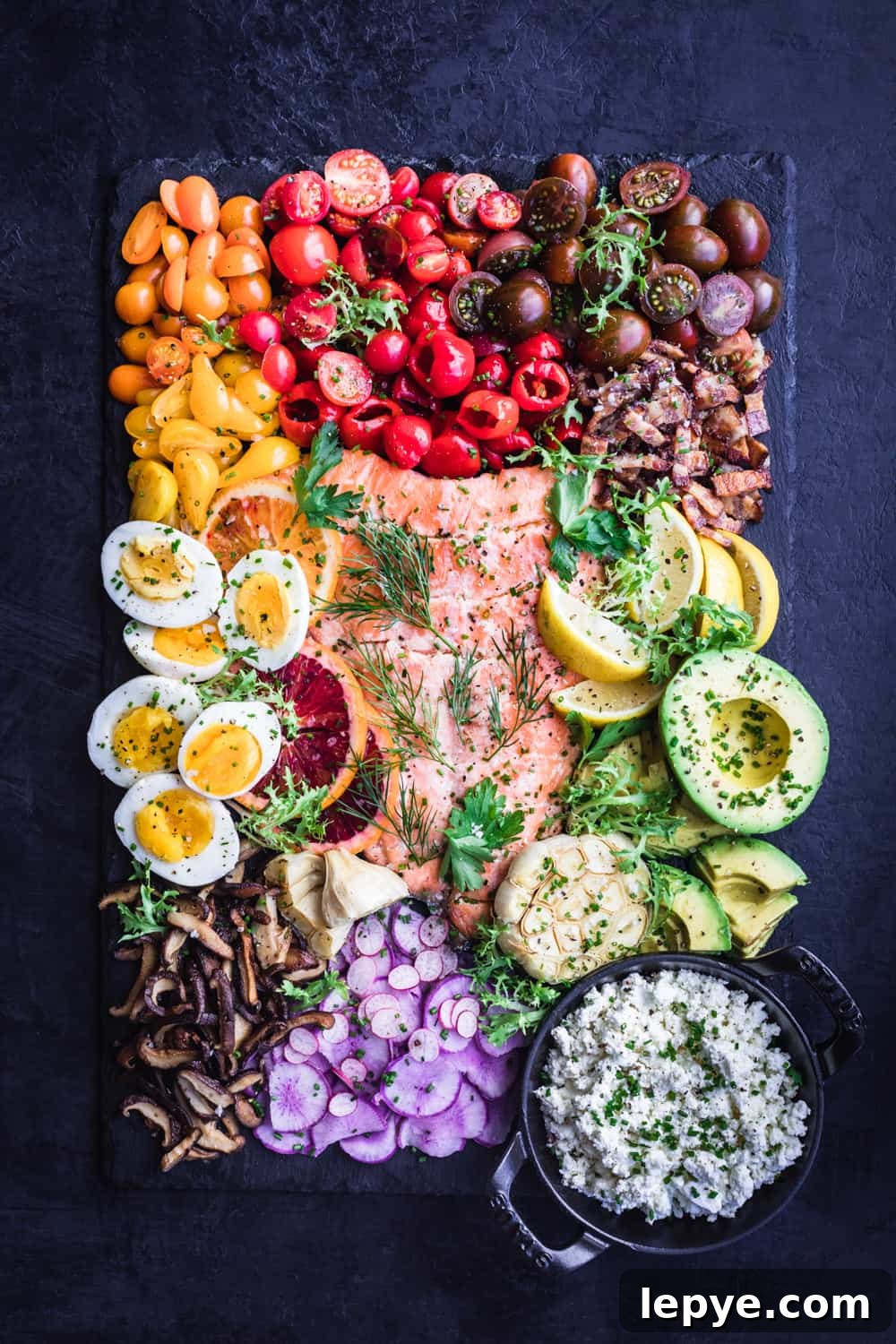 Vibrant Salmon Rainbow Salad Board for Entertaining 4 Salmon Rainbow Party Salad Board with eggs, tomatoes, bacon, avocado, mushroom, feta, radishes, oranges and garlic.