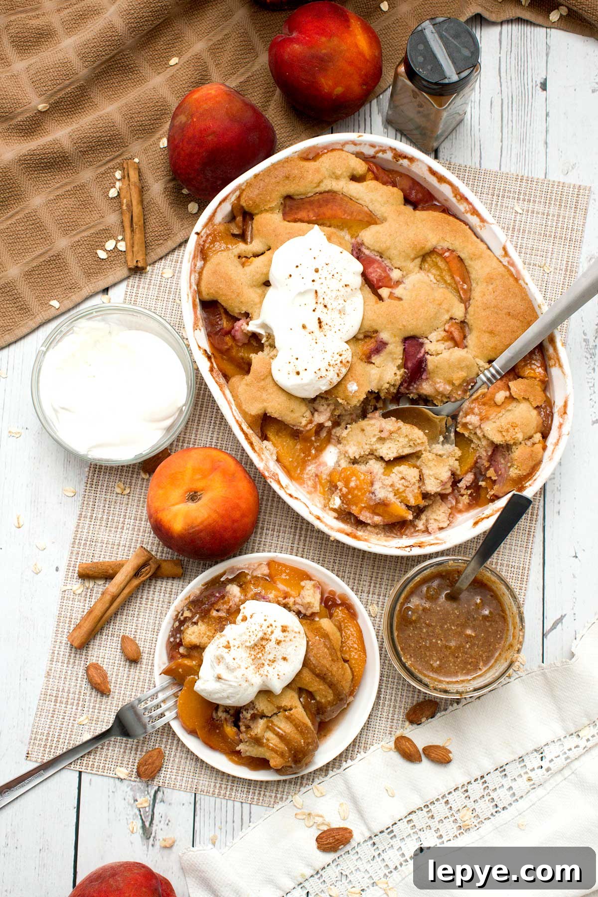 Gluten-Free Peach Cobbler with Almond Butter Caramel Sauce 3 A baking dish with gluten-free peach cobbler with oat and almond flour.