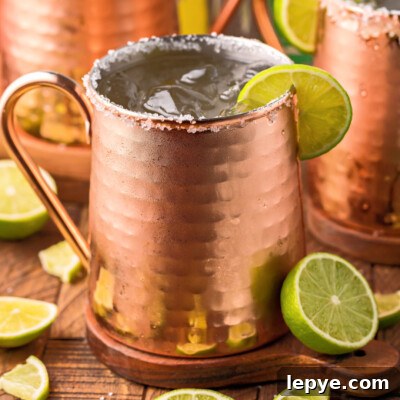 Mexican Mule Cocktail: Classic Tequila Mule Recipe and Tips 6 square image of a mexican mule cocktail in a copper mug with a lime slime on the rim