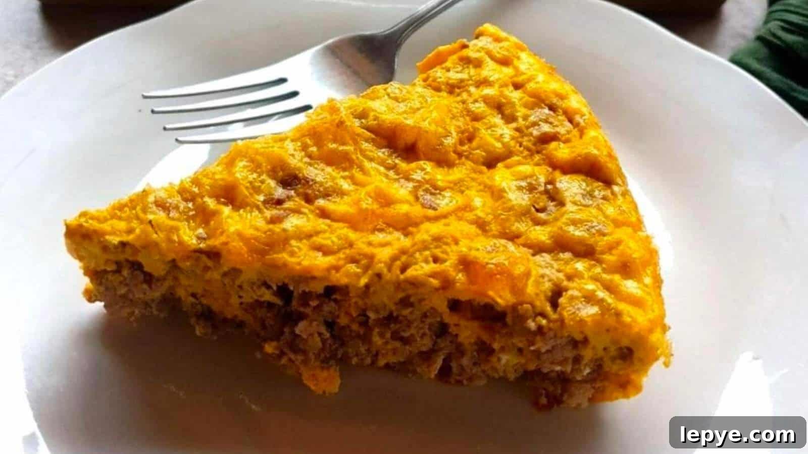 15 High-Protein Breakfasts to Power Your Morning Hustle 11 A person cutting a piece out of a casserole.