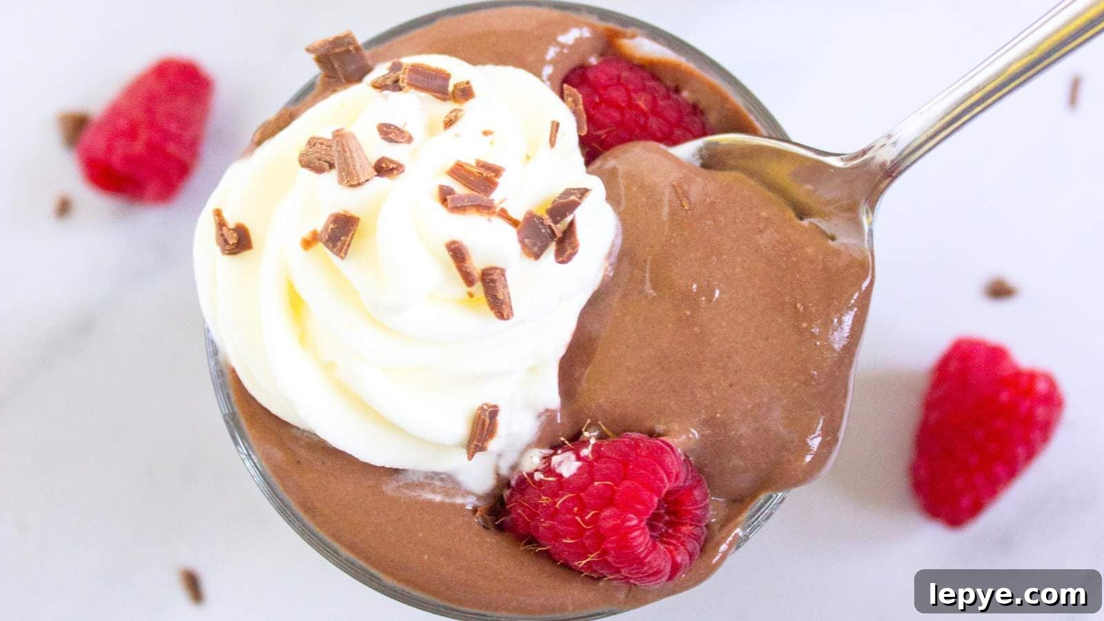 15 High-Protein Breakfasts to Power Your Morning Hustle 7 A glass cup filled with protein pudding topped with whipped cream.