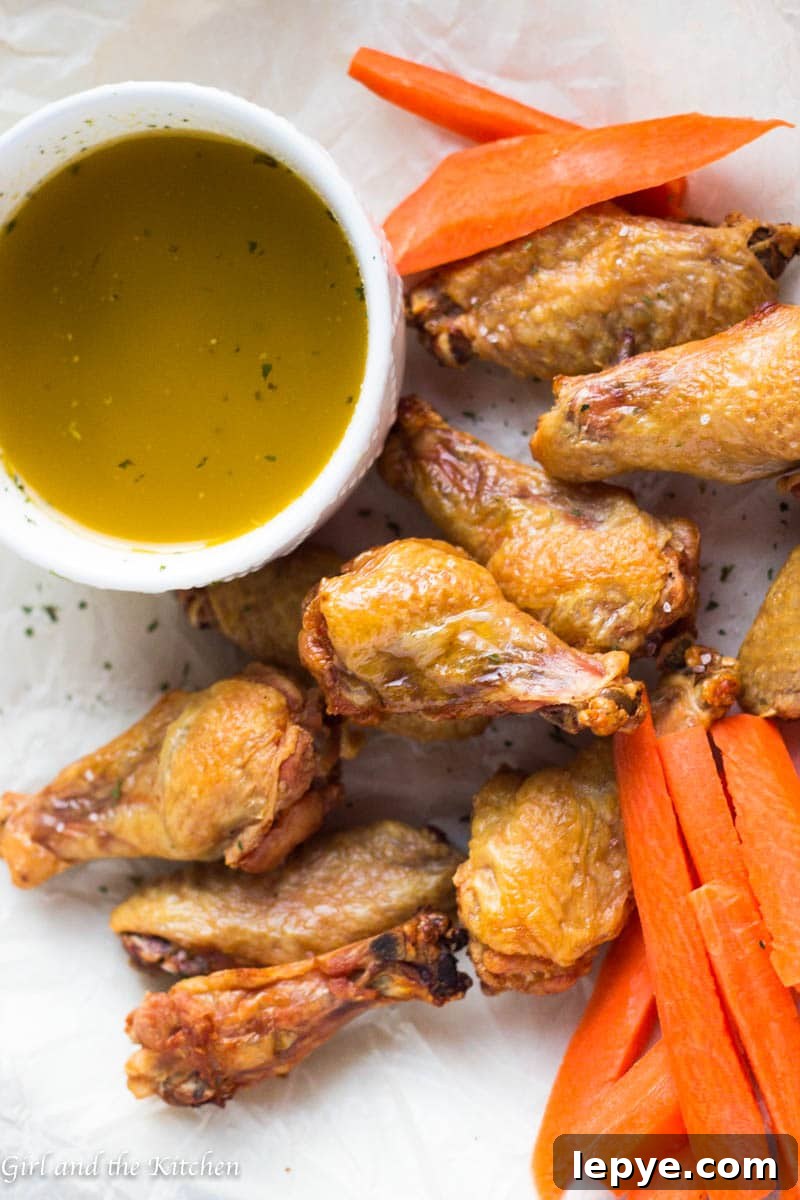 Crispy Oven-Baked Chicken Wings with Garlic Butter Sauce 4 I have discovered how to make seriously CRISPY oven baked chicken wings and they are legit! Perfectly crispy, ridiculously easy and unbelievably tasty! Learn the trick that makes them crisp up in the oven with no effort and allows for most of the fat to drip right off. Leaving you feeling less guilty to dip away in my savory garlic butter sauce.