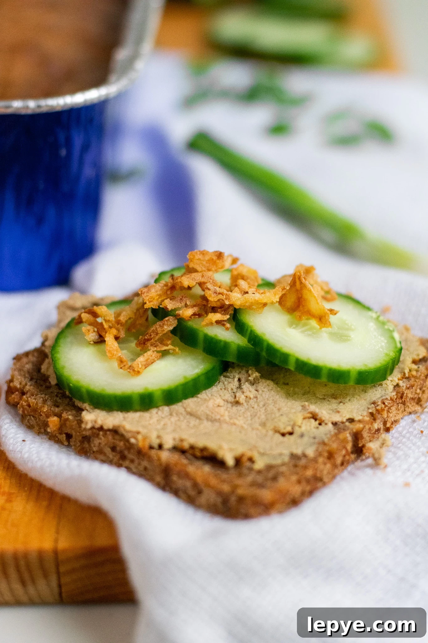 How to Make Classic Danish Leverpostej (Liver Pâté) 12 Liver pate on a piece of rye bread with cucumber and fried onions on top.
