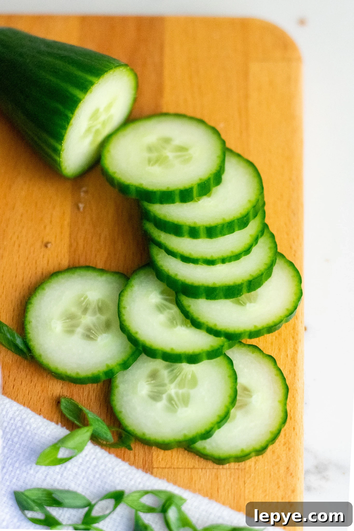 How to Make Classic Danish Leverpostej (Liver Pâté) 7 Slices of cucumber on a cutting board.