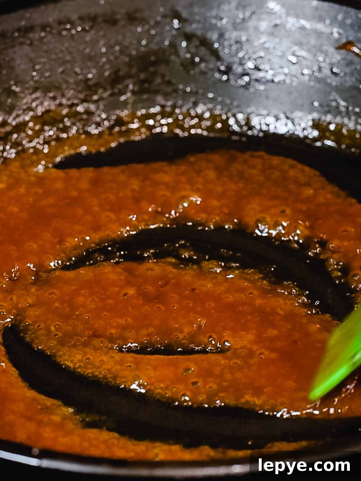 Sauce for hamburg steak reducing in a pan.