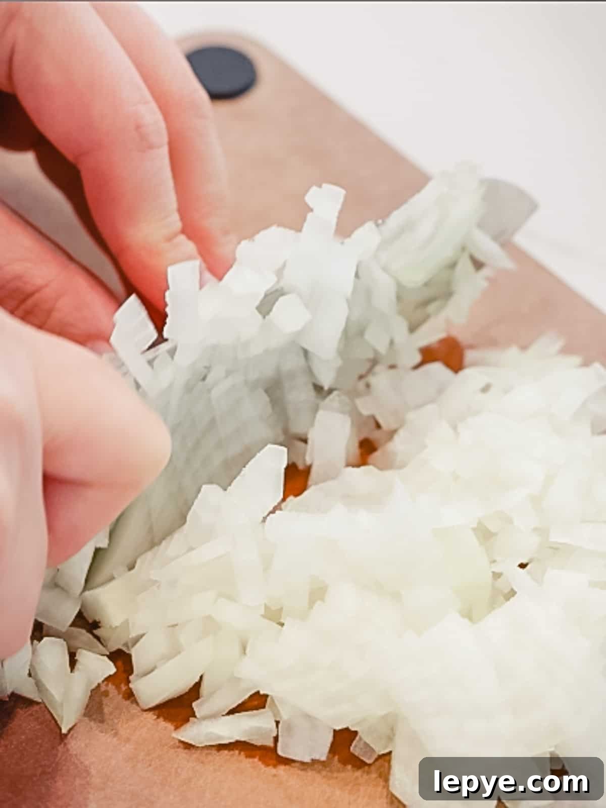 Onions diced on a cutting board.
