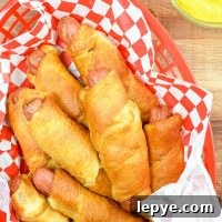 Crispy Air Fryer Pigs in a Blanket Recipe 11 A basket of pigs in a blanket in a red basket.