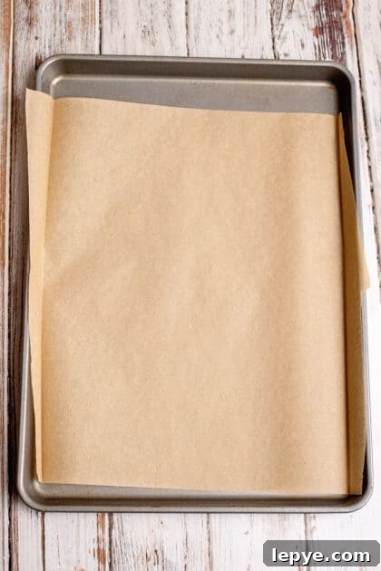 Line baking sheet with parchment paper.