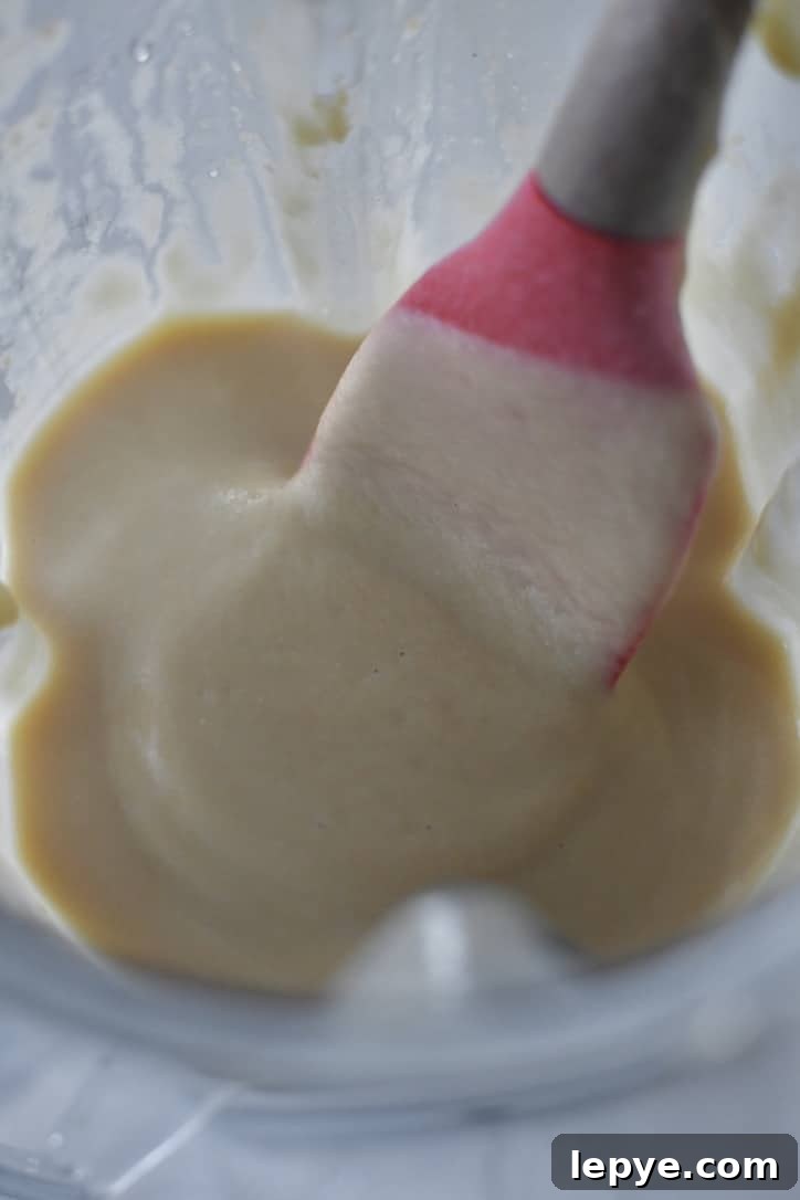 Chickpeas in a high speed blender that have been pureed to a smooth paste.