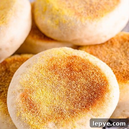 Stacked finished English Muffins on plate.