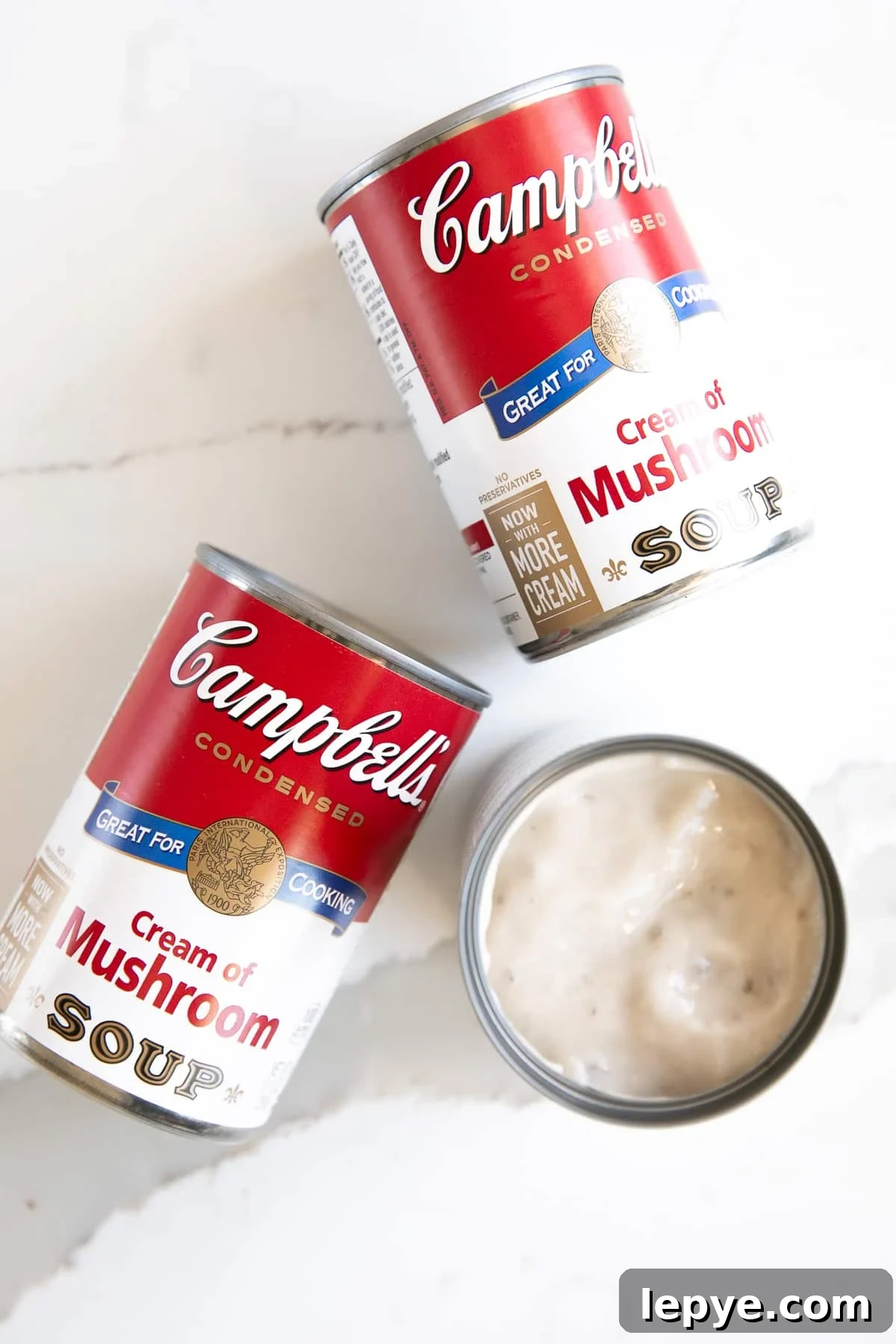 Three cans of Campbell's cream of mushroom soup.